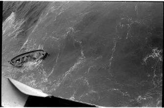 [View from deck of ship, looking down to boat.]