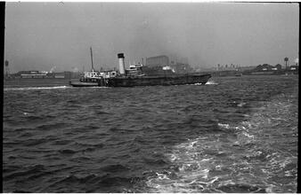 [Tugboat pulling barge on the Hudson River.]