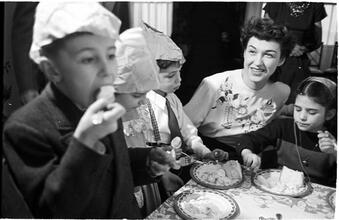 Deaf Children [Eating cake at a party.]