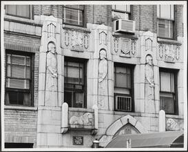 [Medieval imagery carved into the façade of The Waverly apartment house.]