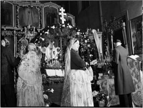 [Worshippers by a decorated altar.]