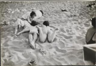[People relaxing on Coney Island beach.]