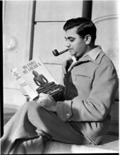 [Man reading a book.]