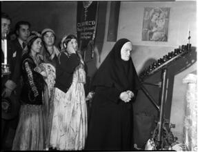 [Worshippers praying at an altar.]