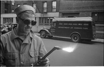 Paddy Wagon [Man with welding equipment used in the making of the television show Paddy Wagon.]