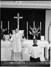 [Priest performing a service.]