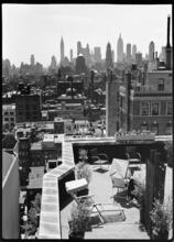 [Midtown Manhattan skyline from rooftop terrace.]