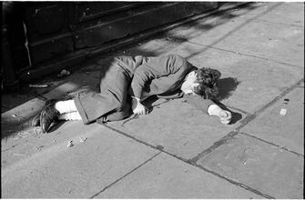 [Destitute man sleeping outside.]