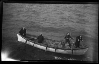 [Men in rowboat next to larger vessel.]