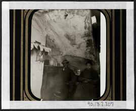 [Black couple in their home.]