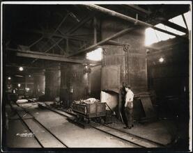 [Interior, manufacturing shop, metal melting furnace oven.]