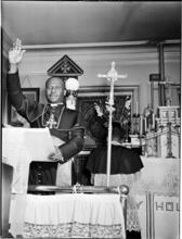 [African American pastor at pulpit.]