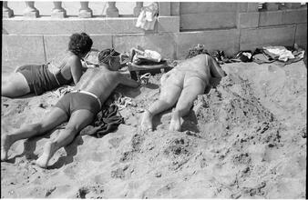 [People relaxing on Coney Island beach.]