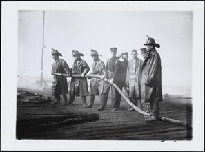 [Firemen with hose.]