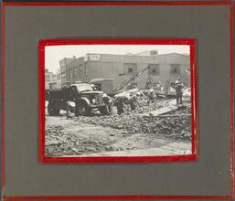 [Cleaning up after a building collapse.]