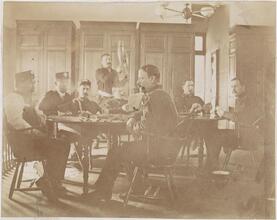 [Firemen sitting around a table.]