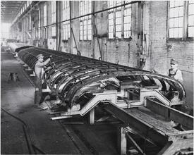 [Men building railroad cars.]