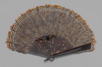 Folding feathered fan of brown and white feathers