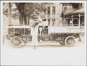 [Firemen with a Knox 1000 gallon fire truck.]