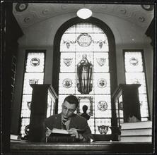 Columbia University [Man studying in a library.]