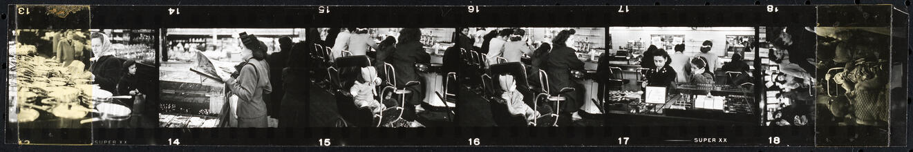 The 5 and 10 [Women shopping and a child in a stroller at the lunch counter in Woolworth's.]