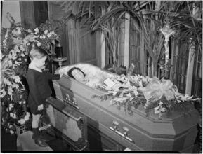 [Boy at a funeral.]