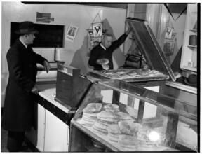 [Man buying bread.]