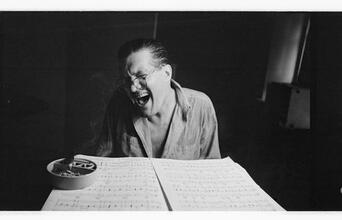 Peter Arno [Arno reading sheet music.]