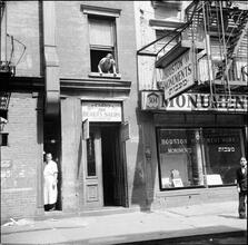 Storefronts--Woman Leaning from Window