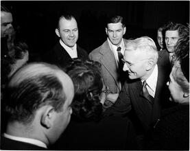 Dale Carnegie [Dale Carnegie talking to a group of people.]