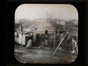 [Family in front of old shanty.]