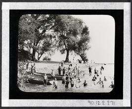 [Young children in the water and on the beach.]
