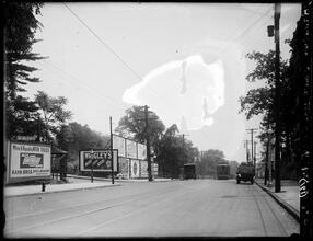 Broadway Series. Looking south from Caryl Avenue, city line. Chevrolet and Wrigley billboard signs at left.