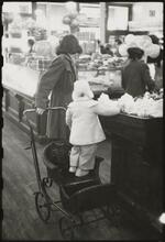 The 5 and 10 [Woman with a child in a stroller at Woolworth's.]