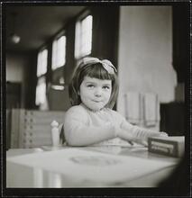 Orphanage [Girl at a table.]
