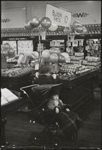 The 5 and 10 [Child in a stroller in Woolworth's.]