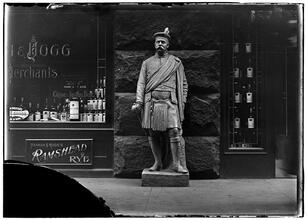 Cigar Store Indian series [Statue of a Scotsman in front of liquor store]