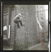 Shoe Shine Boy [Mickey climbing a fence.]