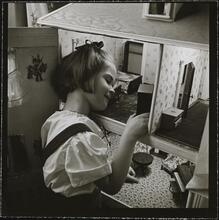 Orphanage [Girl playing with a dollhouse.]