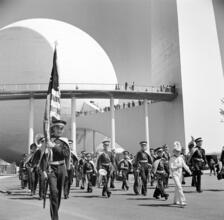[Procession in front of the Perisphere, Helicline and Trylon at the New York World's Fair.]