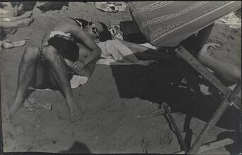 [People relaxing on Coney Island beach.]