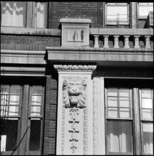 [Snarling lion sculpture on unidentified building.]