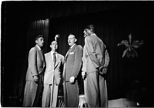 Vaughn Monroe [Monroe and a group of men singing on stage.]