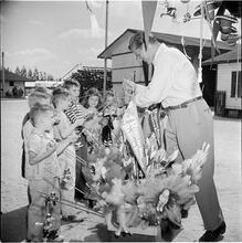 Circus [Man selling toys to children.]
