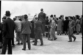 [People waiting on the dock of the Hoboken Ferry Terminal.]