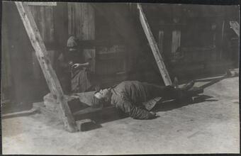 [Homeless man sleeping outside.]