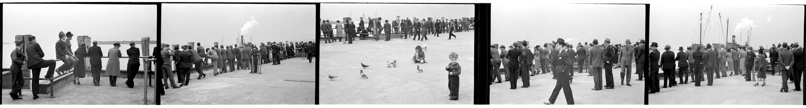 [People waiting on the dock of the Hoboken Ferry Terminal.]