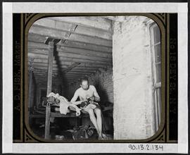 Lodger in Pell St. 7 cents lodging house (Happy Jack's Canvas Palace) going to bed.