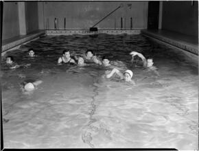 [Boys swimming in pool.]