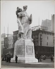 [Policeman in front of monument entitled "Defeat of Slander"]